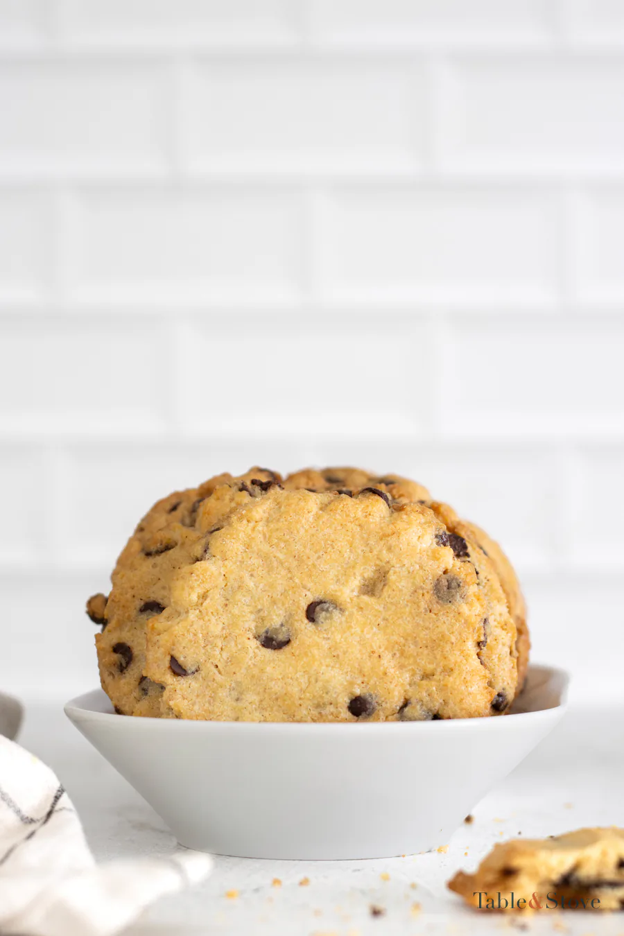 Brown butter chocolate chip cookies standing in a white bowl